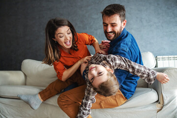 Mother and father playing with their daughter. 