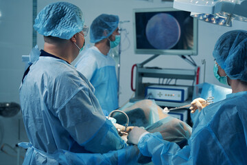 Nurse assisting the doctor during the hysteroscopy