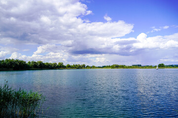 Ehrlichsee near Oberhausen-Rheinhausen. Lake with surrounding landscape in summer. 