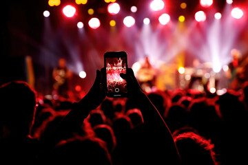 Fototapeta na wymiar Streaming a music concert to social media via smartphone.