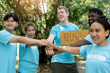 Volunteer  putting their hands  together unity symbol during, stacked huddle together, achieve...