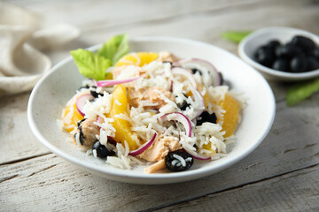Healthy rice salad with orange and salmon