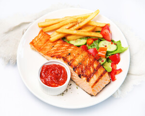 Salmon steak with vegetables on dark background.