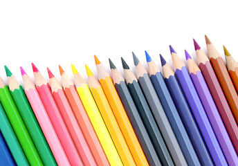 Lots of colored pencils lined upisolated on white background.