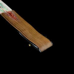 antique fan on a black isolated background with a painting. fan with a close-up painting. retro fan depicting Spanish dancers
