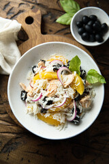 Healthy rice salad with orange and salmon