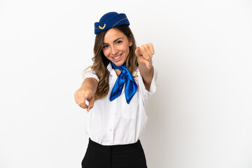 Airplane stewardess over isolated white background points finger at you while smiling