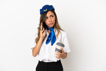 Airplane stewardess over isolated white background holding coffee to take away and a mobile