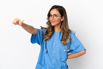 Young surgeon doctor woman over isolated white wall giving a thumbs up gesture