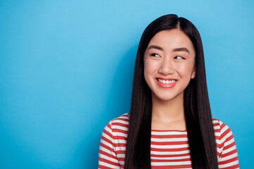 Portrait of charming minded malaysian girl toothy smile look interested empty space isolated on...