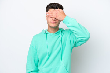 Young handsome caucasian man isolated on white bakcground covering eyes by hands. Do not want to...