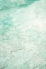 textured and aged old wall painted green and white