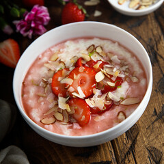 Homemade porridge with strawberry and almond