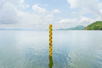 The yellow scale measures the height of the water in the dam. The water in the reservoir is plentiful and is used for agriculture and the village consumption.Reserving water nature in Thailand