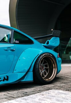 Tacoma, WA, USA
November 2, 2021
RWB Porsche 911 parked showing the front of the car and the drivers side of the car. A concrete overpass is overhead