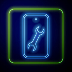 Glowing neon Mobile phone with wrench icon isolated on blue background. Adjusting, service, setting, maintenance, repair. Vector