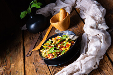Pasta salad with green asparagus, olives and parma ham
