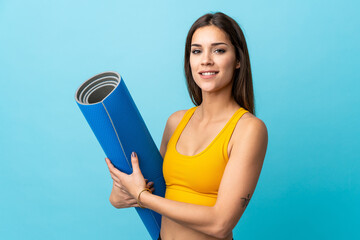 Young caucasian with mat isolated on blue background