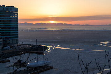 The concept of sunset and sunrise over the mountains on the sea.