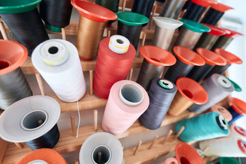 Holder with colourful spools waiting for dressmaker