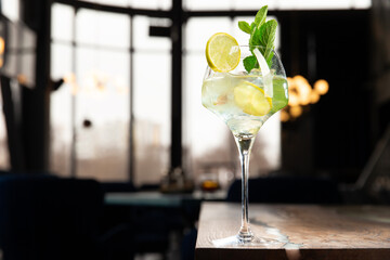 Lemonade or mojito cocktail with lemon and mint, cold refreshing drink or drink with ice.