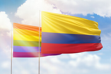 Sunny blue sky and flags of lgbt and colombia