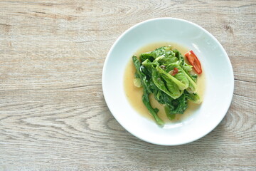 fried Brussels sprout with salty fish in oyster sauce on plate 