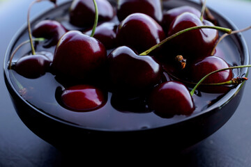 cherries in a plate in water, washed, juicy