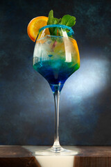 Layered alcoholic cocktail with blue liqueur.