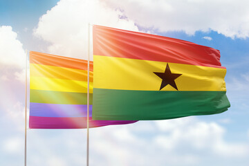 Sunny blue sky and flags of lgbt and ghana