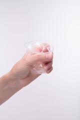 Plastic cup crumpled in hand