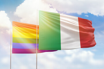Sunny blue sky and flags of lgbt and italy