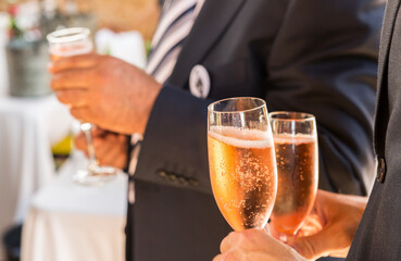 hands with glasses of champagne at party

