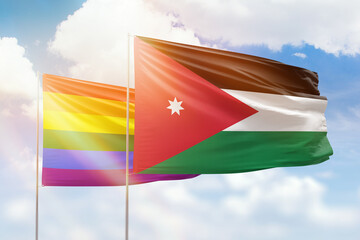 Sunny blue sky and flags of lgbt and jordan