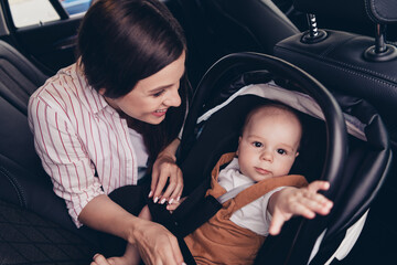 Portrait of peaceful idyllic cheerful mother cute toddler sitting automobile salon ride weekend trip