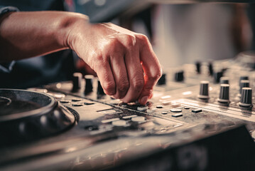 Fototapeta DJ Hands creating and regulating music on dj console mixer in concert nightclub obraz