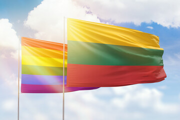 Sunny blue sky and flags of lgbt and lithuania