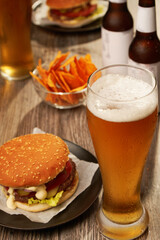 Bottles and glasses of beer with hamburgers
