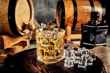Glasses of whiskey with ice in a rustic setting