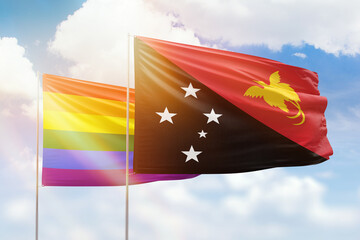 Sunny blue sky and flags of lgbt and papua new guinea