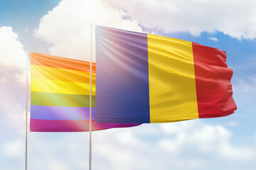 Sunny blue sky and flags of lgbt and romania