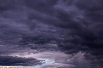 Storm sky with dark blue violet cumulus rainy clouds background texture, thunderstorm