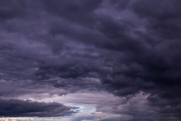 Obraz premium Storm sky with dark blue violet cumulus rainy clouds background texture, thunderstorm