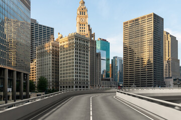 Empty urban asphalt road exterior with city buildings background. New modern highway concrete construction. Concept of way to success. Transportation logistic industry fast delivery. Chicago. USA.