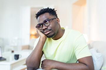 Close up profile view of pensive upset African American man look in distance thinking of personal problems, thoughtful sad biracial male feel depressed lost in thoughts pondering, having dilemma