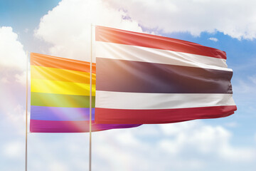 Sunny blue sky and flags of lgbt and thailand