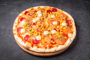 hot delicious traditional italian pizza on a dark stone background