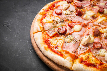 hot delicious traditional italian pizza on a dark stone background