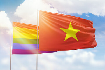 Sunny blue sky and flags of lgbt and vietnam