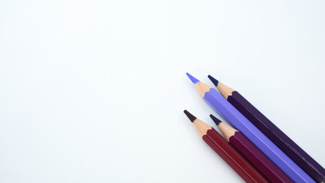 Purple pencils on a purple divided background in a close up view